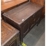 A 17th Century oak coffer, having geometric moulded triple panel front, raised on square section