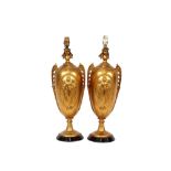 A pair of 19th Century gilt metal baluster table lamps, with raised classical and foliate