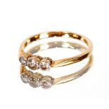 An 18ct gold and three stone diamond set ring, size "O"