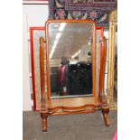 A Victorian mahogany cheval mirror, raised on scrolled arms and serpentine platform base,