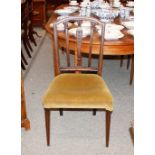A set of four 19th Century mahogany rail back dining chairs, having upholstered stuff over seats,