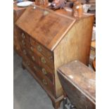 A George III mahogany bureau, the fall front opening to reveal a stepped interior of drawers and