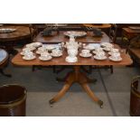 A Regency mahogany supper table, the rectangular snap top raised on a turned column and reeded