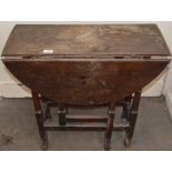 An 18th Century oak gate leg table, raised on turned supports terminating in Braganza type feet,