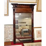 A Regency mahogany and ebony strung pier mirror, having inverted breakfront pediment above turned