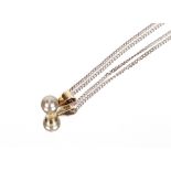 A 9ct white gold and pearl set pendant, hung to an 18ct white gold chain