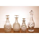 Three hobnail cut ring neck decanters, having mushroom stoppers; and a baluster shaped cut glass