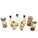 A collection of various glass and silver mounted scent bottles, hair tidies, rouge pots etc.