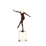 An Art Deco bronze and ivory figure of a dancing girl, raised on a block glass plinth base, 27.5cm