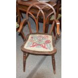 An antique yew wood and elm Windsor type elbow chair, having cross over back rails above later