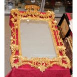 A gilt framed wall mirror, in the Chinese Chippendale manner surmounted by a stepped pediment and