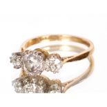 An 18ct gold and platinum ring set central ¾carat diamond flanked by two ¼carat diamonds, approx.