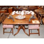 A 19th Century mahogany breakfast table, the rectangular tilt top raised on a turned baluster column