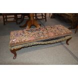 An oak framed long stool with tapestry upholstered seat, raised on cabriole supports, 115cm