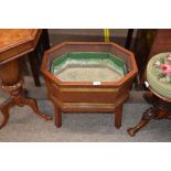 An Edwardian mahogany and brass bound planter, flanked by loop carrying handles and raised on square