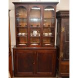 A 19th Century mahogany bookcase, the upper adjustable shelves enclosed by a pair of arched panelled