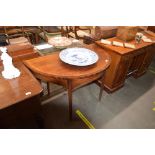 A 19th Century mahogany cross banded and box wood strung D shaped serving table, raised on square