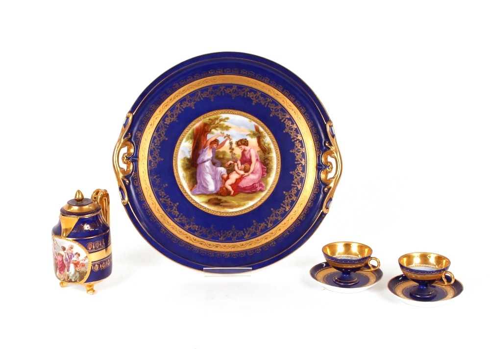 A Vienna porcelain part cabaret set, comprising tray, chocolate pot, and two cups and saucers