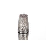 An interesting continental white metal thimble, with figural decoration