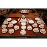 A Minton "Chinese Rose" pattern tea set including cups, saucers, milk jug, muffin dish, slops bowl