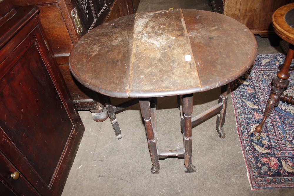 An 18th Century oak gate leg table, raised on turned supports terminating in Braganza type feet, - Image 14 of 23