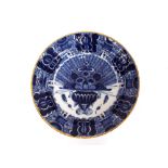 A pair of Delft shallow dishes, decorated central vase of flowers and foliate borders, 31cm