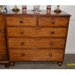 A 19th Century mahogany chest, fitted two short and three long graduated drawers raised on turned