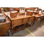 A good quality reproduction oak dresser base, fitted three drawers raised on a shaped apron and