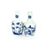 A pair of Oriental blue and white vases, having scenic decoration and symbols to the necks, 19.5cm
