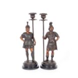A pair of late 19th / early 20th Century candlesticks, modelled as Roman soldiers, 36.5cm high
