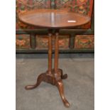 A small mahogany circular wine table, the dished top raised on a triple column support and pad feet,