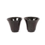 A pair of small spinach jade cups, of tapering form, 5cm high, 6cm dia. overall, contained in a