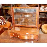 A 19th Century mahogany serpentine fronted swing toilet mirror, the rectangular plate raised on