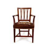 A Georgian mahogany elbow chair, with pierced rail back above tapering out swept arms, needlepoint