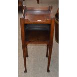 A Georgian mahogany tray top bedside cupboard, raised on rounded tapering supports and pad feet,