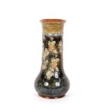 A Doulton baluster vase, having raised foliate decoration on a green and brown mottled ground,