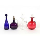 Three various Victorian glass claret jugs and a blue glass decanter