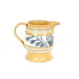 A 19th Century English pottery baluster jug, having central band of blue flowers within cream and
