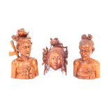 A pair of finely carved hardwood Balinese heads; and a carved hardwood mask (3)