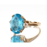A 9ct gold dress ring, set with a pale blue stone flanked by small diamonds, approx. total weight