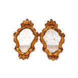 A pair of 19th Century gilt framed Florentine wall mirrors, of cartouche shape with leaf decoration,