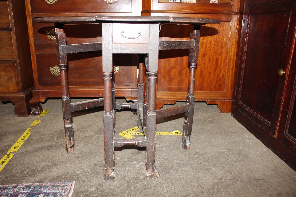 An 18th Century oak gate leg table, raised on turned supports terminating in Braganza type feet, - Image 10 of 23