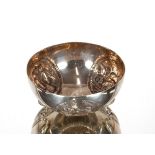 A Greek white metal bowl, with raised panels of heraldic emblems on scrolled feet, stamped 900, 12cm