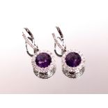 A pair of white gold ear-rings marked 750, each set with amethyst surrounded by diamonds 4.2gms
