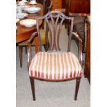 A George III Hepplewhite style mahogany elbow chair, swag decorated splat back, Regency striped