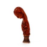 A 19th Century desk seal, having white metal and red stone set terminal, the carved fruitwood handle