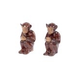 Two unusual antique pottery figures of seated monkeys, 18cm high possibly joss holders