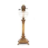 An Edwardian alabaster and gilt metal table oil lamp, having cut glass reservoir above classical