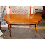 A pair of Victorian mahogany D shaped side tables, raised on ring turned tapering supports,