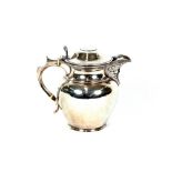 An Edwardian Scottish silver baluster jug, the domed lid inset with a coin, the spout with mask